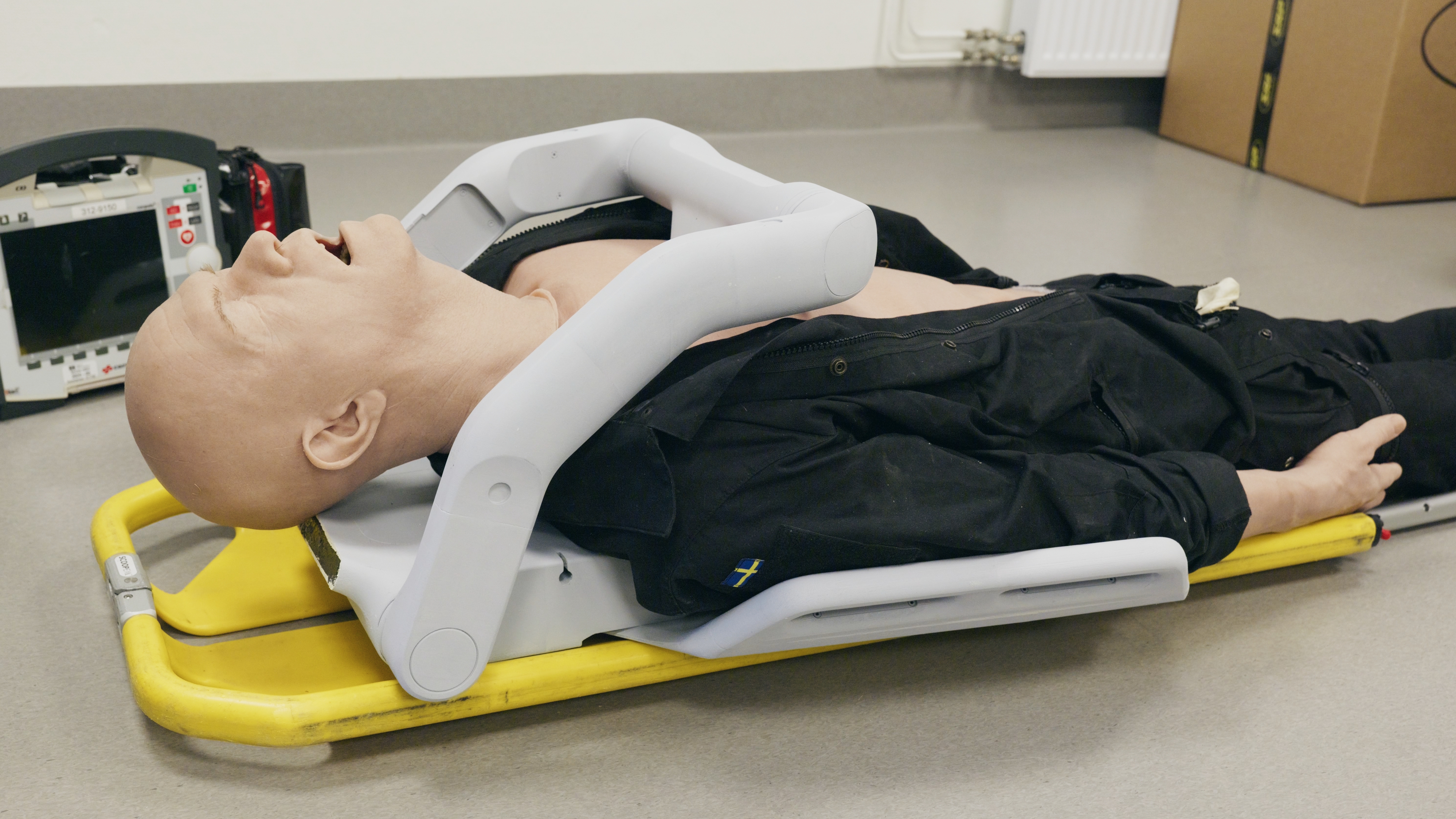 Patient backboard placement showing the wrap-around arm mechanism