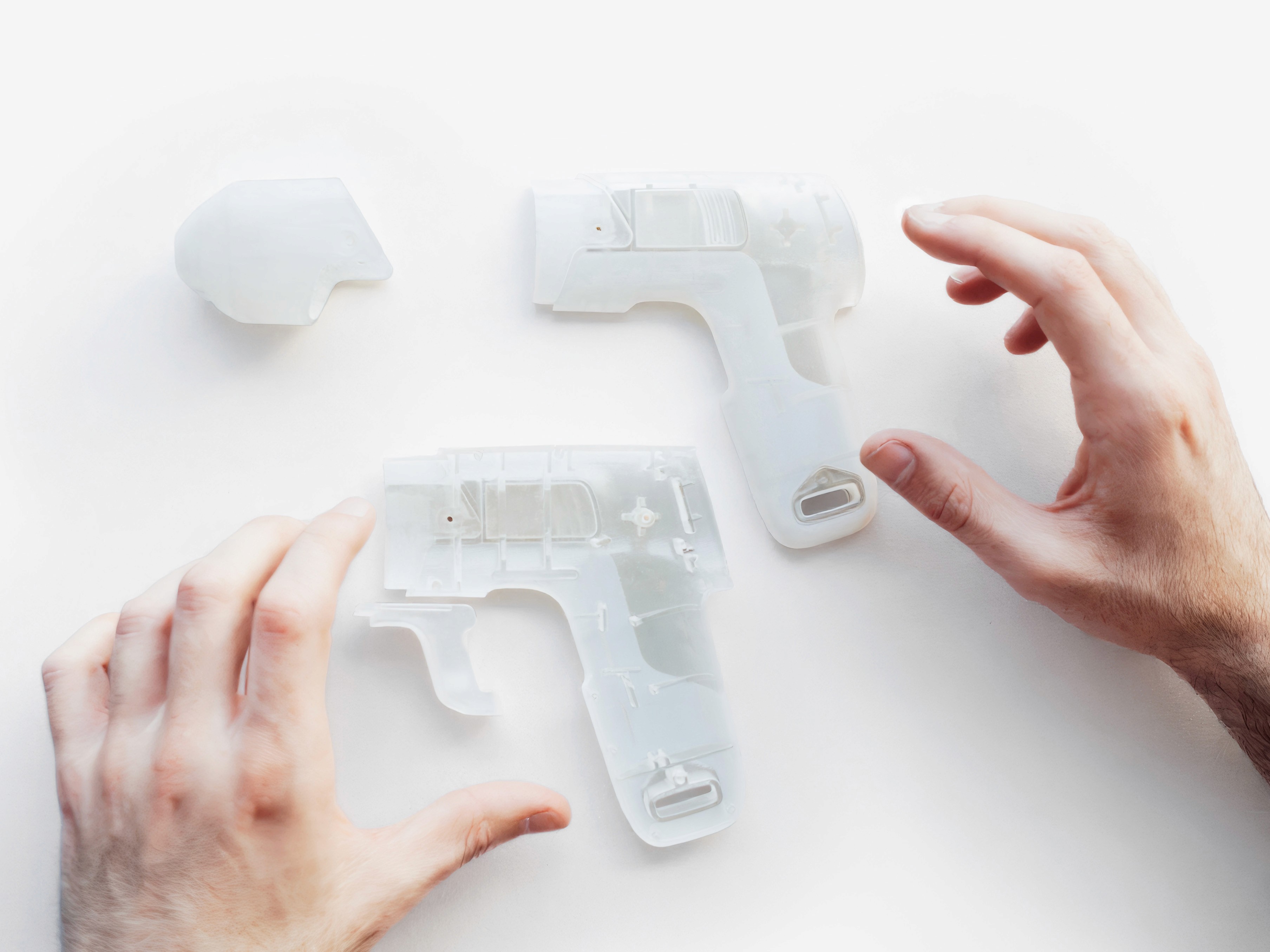 3D printed prototype parts laid out showing internal structure and grip ergonomics