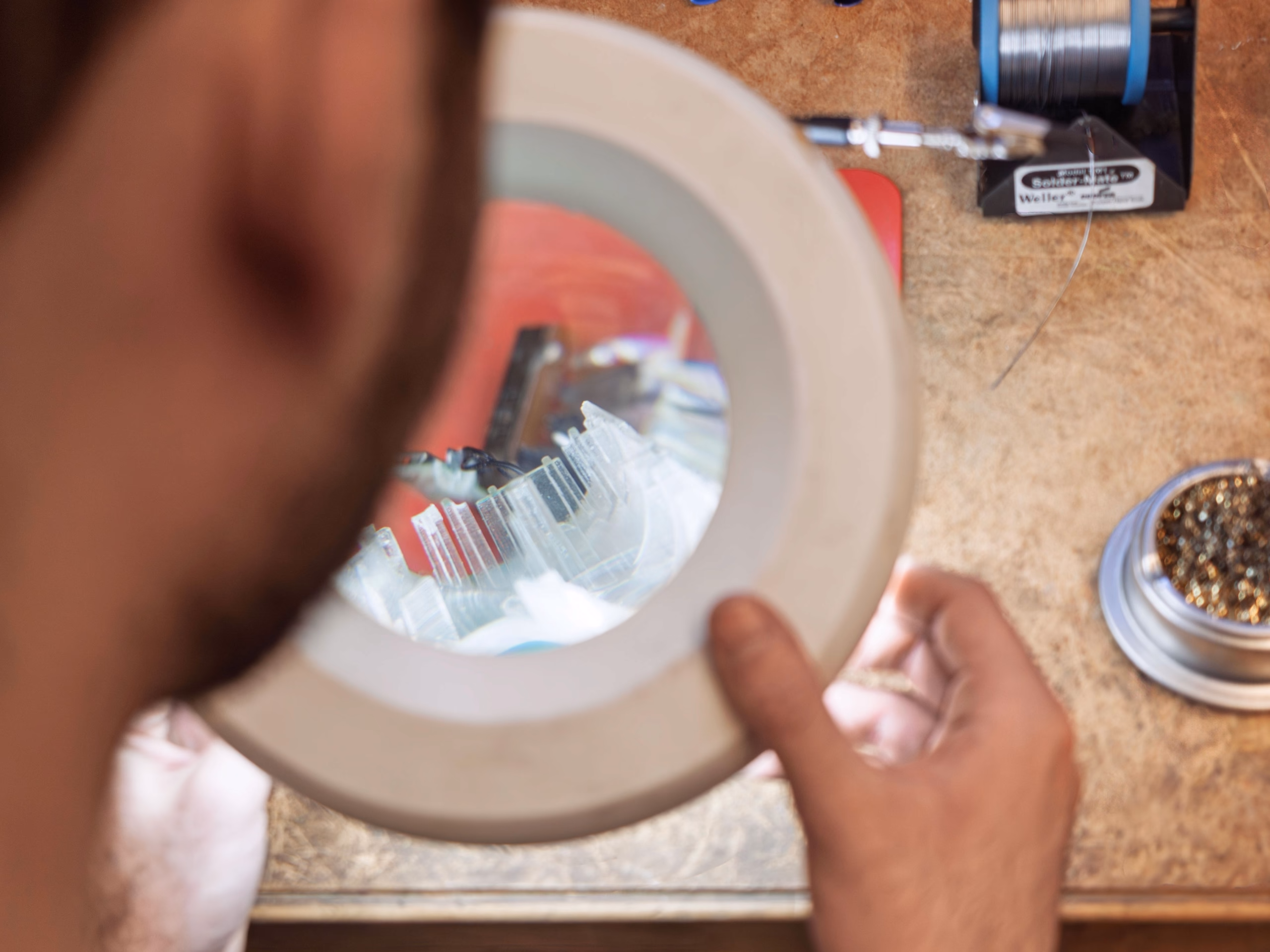 Designer working on prototype refinements using precision tools
