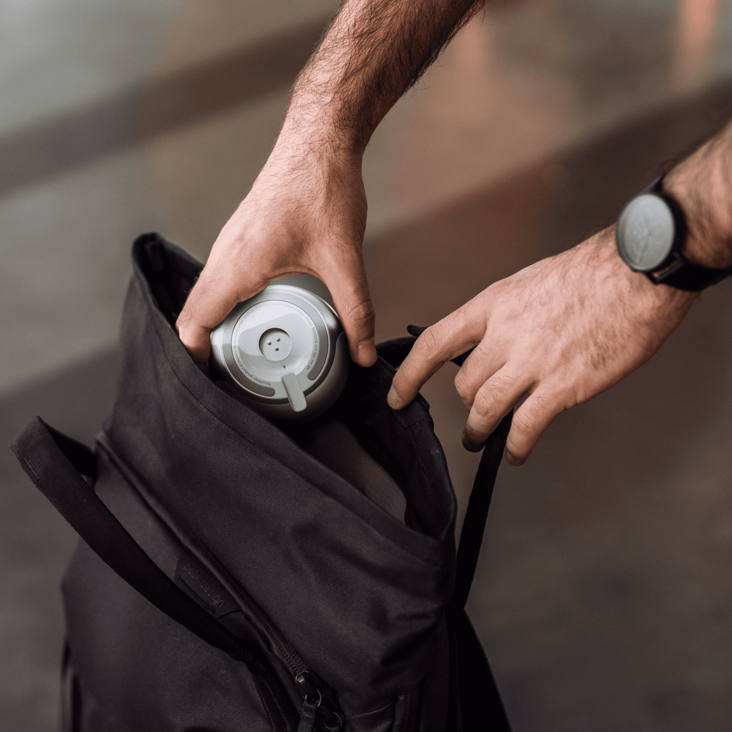 Soune device attached to a backpack strap for easy carrying